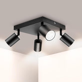Modern black ceiling light fixture with four adjustable lights on a neutral background
