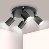 Modern ceiling light fixture with four lights on a neutral background