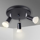 Black ceiling light fixture with three white lights on a gray background