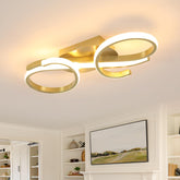 Modern ceiling light fixture in a living room setting with a TV and shelves.