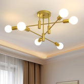 Modern gold chandelier with multiple light bulbs in a room setting.