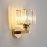 Gold wall sconce with crystal detailing on a gray background