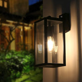 Outdoor wall light fixture on a building exterior with warm glow