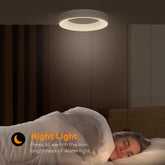 Person lying in bed with a night light above, text indicating it can be switched on and off.