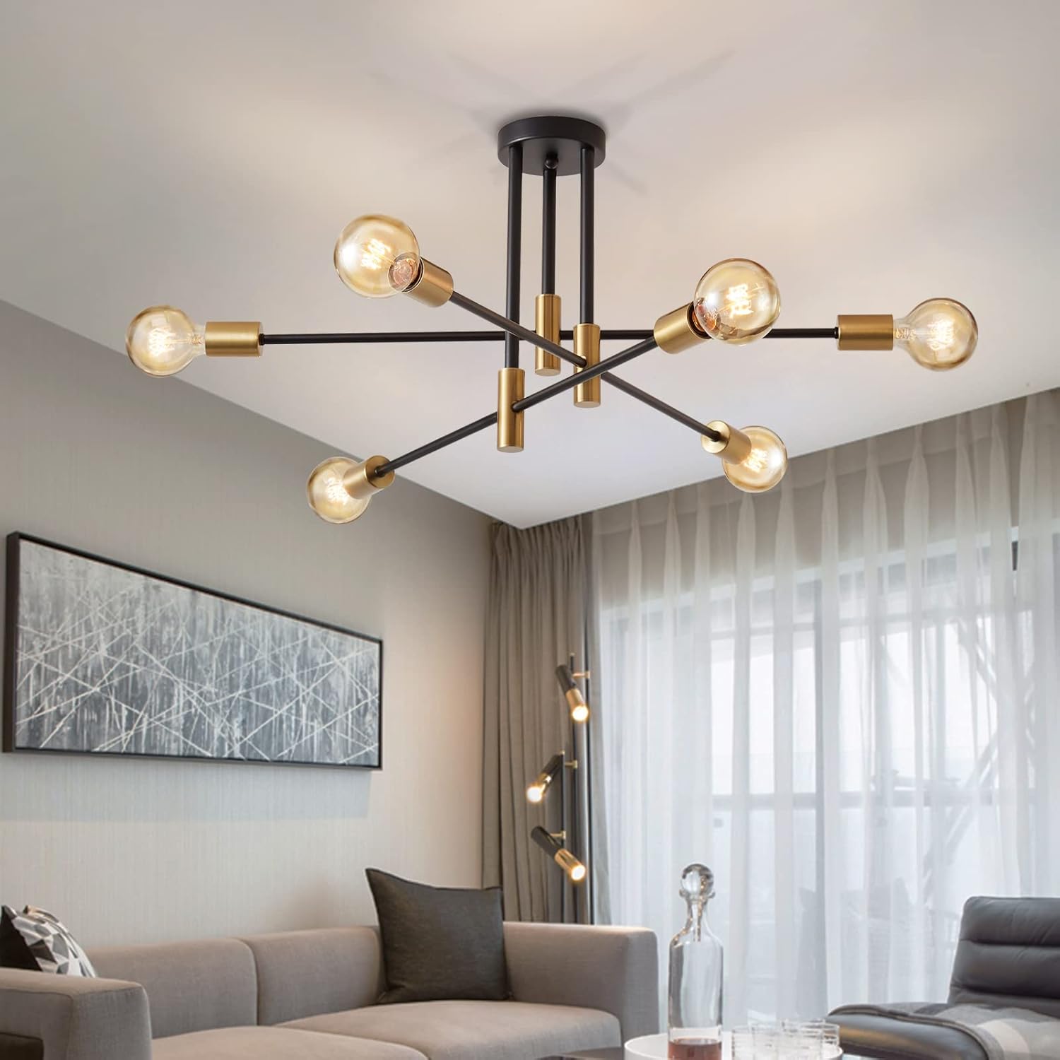 Modern chandelier in a living room setting with a sofa and artwork.