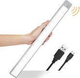 Hand holding a USB light bar with a white background