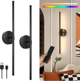 Black wall-mounted light fixture with remote control in a living room setting