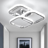 Modern ceiling light fixture in a room with a framed picture on the wall.