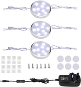 Set of LED puck lights with installation accessories on a white background