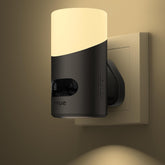 Energy-efficient plug-in night light in a bedroom, activated by motion detection