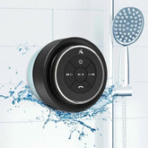 Black shower speaker with water splashes on a bathroom background