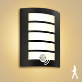 Black wall light fixture with motion sensor on a beige background