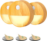 Three round wooden night lights with motion sensor on a white background