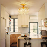 Modern kitchen with a chandelier, island, and appliances.