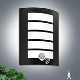 Black outdoor wall light fixture with sensor on a gray background