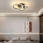 Modern bedroom with a ceiling light fixture and abstract wall art.