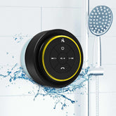 Black and yellow shower speaker with water splashes on a tiled shower background