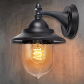 Black outdoor wall light fixture with a lit bulb on a textured wall background