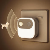 Wall-mounted night light with motion sensor on a brown background