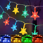 String lights with star-shaped bulbs in red, green, blue, and yellow on a dark background.