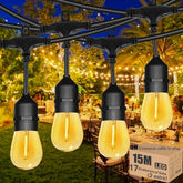Outdoor string lights with glowing bulbs in a garden setting, featuring a box of additional LED bulbs.