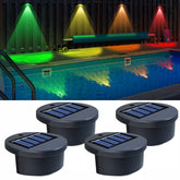 Set of 8 solar-powered wall lights illuminating a garden fence.