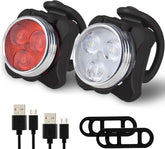 Bicycle lights set with USB charging cables and mounting brackets on a white background