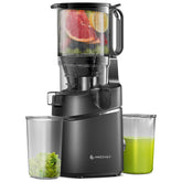 Black juicer with fruits and vegetables being juiced, displaying a clear container of green juice.