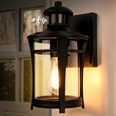 Black outdoor wall light fixture with a visible bulb, mounted on a wall.