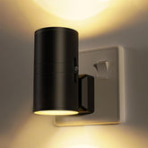Black wall-mounted light fixture on a neutral wall