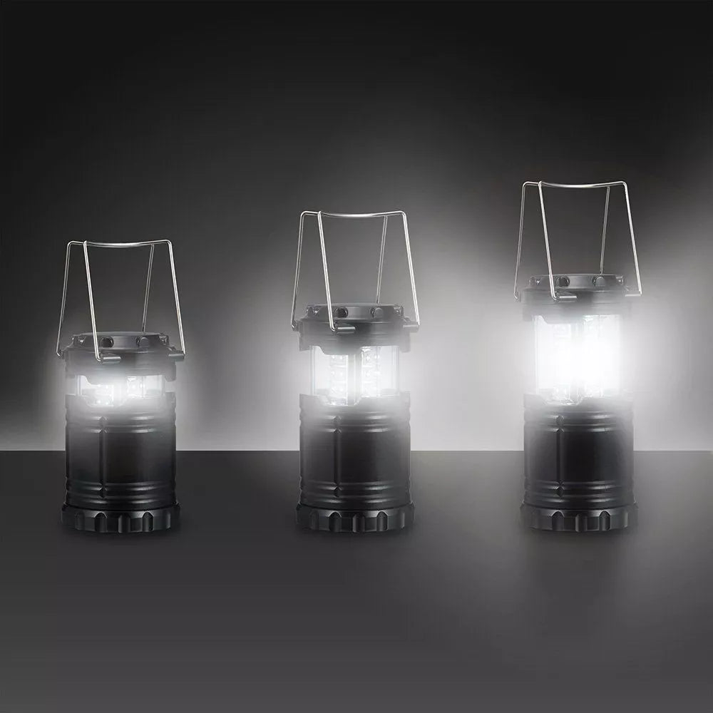 LED lantern beside hiking boots