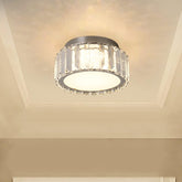 Ceiling light fixture with crystal accents on a beige ceiling