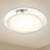 Ceiling light fixture with sensor on a beige ceiling