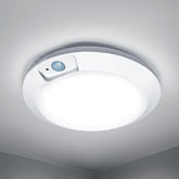 Ceiling light fixture with sensor on a white ceiling