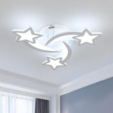 Ceiling light fixture with star and moon design in a room.