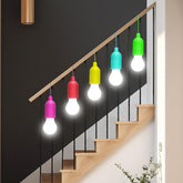 Colorful pendant lights hanging from a staircase railing.