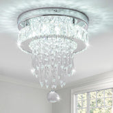 Crystal chandelier hanging from a ceiling with a window in the background