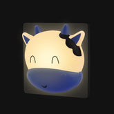 Cute animal-shaped night light with blue and beige colors on a black background