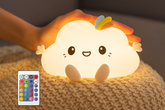Cute cloud-shaped night light with a remote control on a textured surface