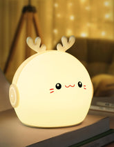 Cute deer-shaped night light on a surface with a blurred background