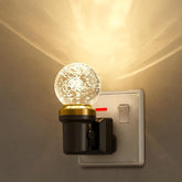 Decorative night light attached to a wall switch with a warm glow.