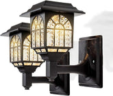 Decorative outdoor wall light fixture with intricate glass design on a white background