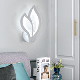 Decorative wall light fixture on a gray wall with a Loewe product and vase in the foreground.