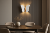 Dining room with a butterfly-shaped wall light fixture, wooden table, and chairs.