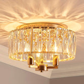 Gold and crystal ceiling light fixture on a neutral background