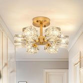 Gold ceiling light fixture with crystal-like glass shades in a room setting.