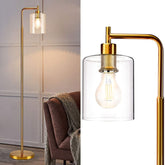 Gold floor lamp with clear glass shade in a room setting
