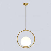 Gold pendant light with a white bulb on a light gray background