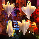 Halloween-themed decorations with ghost figures and pumpkins in a festive setting.