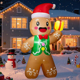 Inflatable gingerbread man decoration in front of a house with Christmas lights and decorations.